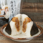 海老天むす ファミリーマート 「なごやめし」として人気の天むす。醤油・あおさ・コショウでしっかり味付けをした海老天を2尾入れた商品。
※静岡県（東部）では取り扱いなし。
