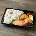 ファミリーマートの【北陸】幕の内弁当（福井梅使用）を比較する。税込価格：598円。焼鮭・厚焼きたまご・かき揚げ・コロッケ・煮物・煮豆などバラエティ豊かなおかずを盛り込んだ幕の内弁当です。ごはんには福井梅をトッピングしました。