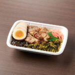 炙りチャーシューごはん ファミリーマート 甘じょっぱいタレで味付けをした炙りチャーシューとごま高菜でご飯が進むお弁当です。醤油味のゆでたまごを添えました。