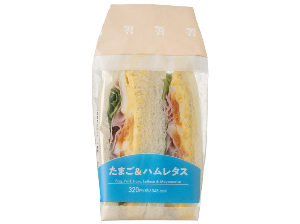 セブンイレブンのたまご＆ハムレタスサンドを比較する。税込価格：346円、カロリー：307kcal、1円あたりカロリー：0.89kcal/円、たんぱく質：12.5g、1円あたりたんぱく質：0.04g/円、脂質：17.8g、炭水化物：24.8g、糖質：23.5g、食物繊維：1.3g、食塩相当量：1.5g。たまご、ハムとレタスを挟んだサンドイッチです。アレルギー：卵、乳、小麦。