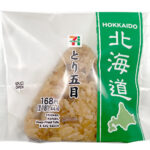 セブンイレブンのとり五目おむすびを比較する。税込価格：181円、カロリー：213kcal、1円あたりカロリー：1.17kcal/円、たんぱく質：5.2g、1円あたりたんぱく質：0.03g/円、脂質：2.4g、炭水化物：43.1g、糖質：42.4g、食物繊維：0.7g、食塩相当量：1.4g。鶏肉の旨味と野菜の自然な甘みが感じられ、具材の食感を楽しめるとり五目ご飯のおむすびです。アレルギー：小麦。