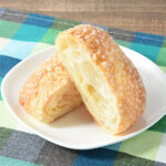 ファミリーマートのバタークロワッサンメロンパン。税込価格：158円。バターの風味が豊かでジューシーなクロワッサン生地に、ザラメをトッピングしたビス生地を被せて焼き上げたメロンパンです。