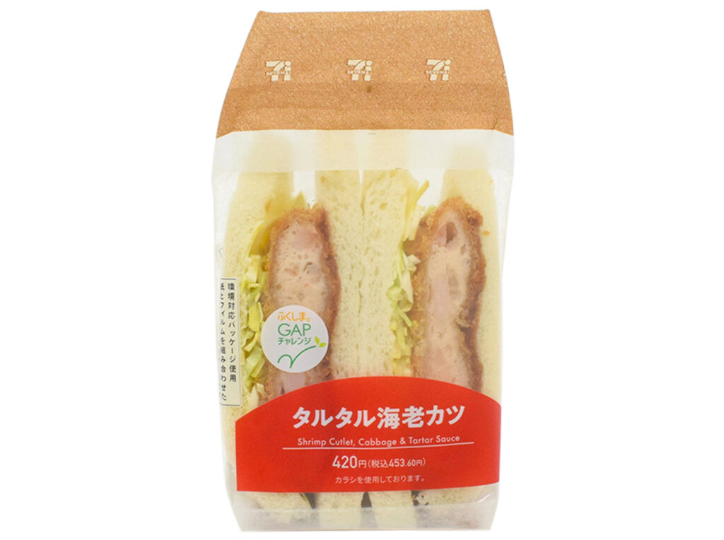 セブンイレブンのタルタル海老カツサンドを比較する。税込価格：454円、カロリー：457kcal、1円あたりカロリー：1.01kcal/円、たんぱく質：12.9g、1円あたりたんぱく質：0.03g/円、脂質：25g、炭水化物：46.1g、糖質：44g、食物繊維：2.1g、食塩相当量：2.5g。海老の剥き身を使用した食感の感じられる海老カツに、相性の良いタルタルソースとキャベツを組み合わせたサンドイッチです。アレルギー：卵、乳、小麦、えび。