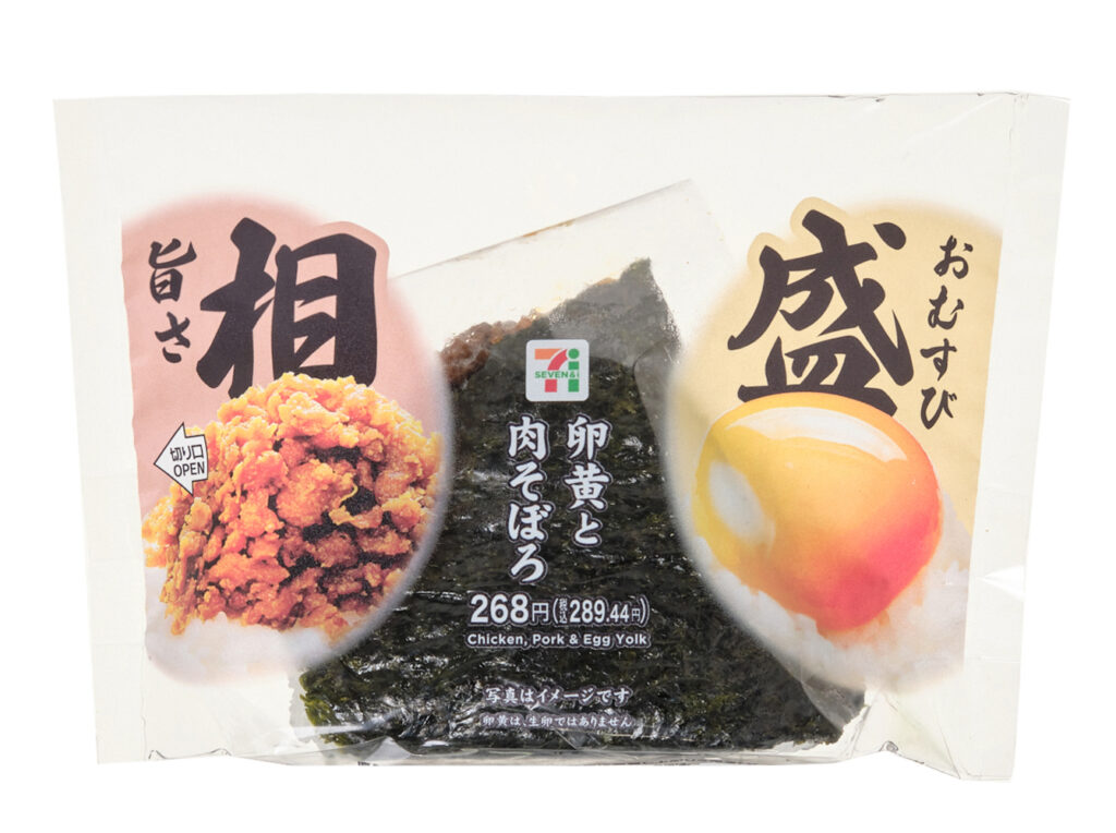 セブンイレブンの旨さ相盛おむすび 卵黄と肉そぼろを比較する。税込価格：289円、カロリー：317kcal、1円あたりカロリー：1.10kcal/円、たんぱく質：8.9g、1円あたりたんぱく質：0.03g/円、脂質：6.3g、炭水化物：57.6g、糖質：54.8g、食物繊維：2.8g、食塩相当量：1.5g。中具だけではなく、おにぎりのてっぺんにも具を盛付けた、一口目から具材が味わえるおむすびです。具材は人気の「卵黄」と「肉そぼろ」を組み合わせました。アレルギー：卵、小麦。