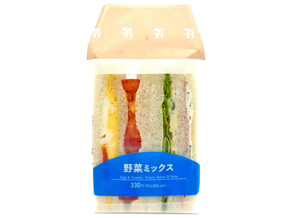 セブンイレブンの野菜ミックスサンドを比較する。税込価格：356円、カロリー：294kcal、1円あたりカロリー：0.82kcal/円、たんぱく質：8.7g、1円あたりたんぱく質：0.02g/円、脂質：14.8g、炭水化物：32.6g、糖質：30.4g、食物繊維：2.2g、食塩相当量：1.5g。様々な具材を味わえる野菜のミックスサンドです。パン生地をよりふんわりとした食感に変更しました。アレルギー：卵、乳、小麦。