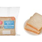 セブンイレブンの７プレミアム 全粒粉入り食パン ３枚入。税込価格：117円、カロリー：168kcal、たんぱく質：5.9g、脂質：2.8g、炭水化物：31.2g、糖質：28.4g、食物繊維：2.8g、食塩相当量：0.7g。全粒粉の香ばしさを楽しめる食パンです。アレルギー：乳、小麦。
