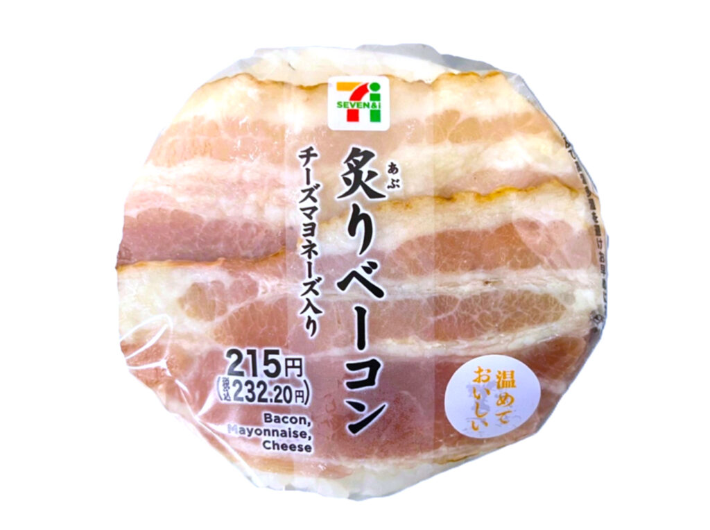 セブンイレブンの炙りベーコンおむすび （チーズマヨネーズ入）を比較する。税込価格：232円、カロリー：281kcal、1円あたりカロリー：1.21kcal/円、たんぱく質：6.6g、1円あたりたんぱく質：0.03g/円、脂質：11.3g、炭水化物：39g、糖質：37.4g、食物繊維：1.6g、食塩相当量：1.8g。表面に盛り付けたベーコンと中具に入れたチーズマヨネーズソースに相性のよい、ペッパーライスを合わせたおむすびです。アレルギー：卵、乳、小麦。