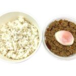 セブンイレブンの温玉とりそぼろ丼（麦ごはん）を比較する。税込価格：518円、カロリー：497kcal、1円あたりカロリー：0.96kcal/円、たんぱく質：19.5g、1円あたりたんぱく質：0.04g/円、脂質：12.2g、炭水化物：78.1g、糖質：76.3g、食物繊維：1.8g、食塩相当量：2.5g。定番のとりそぼろに半熟卵を合わせた丼ぶりです。アレルギー：卵、小麦。