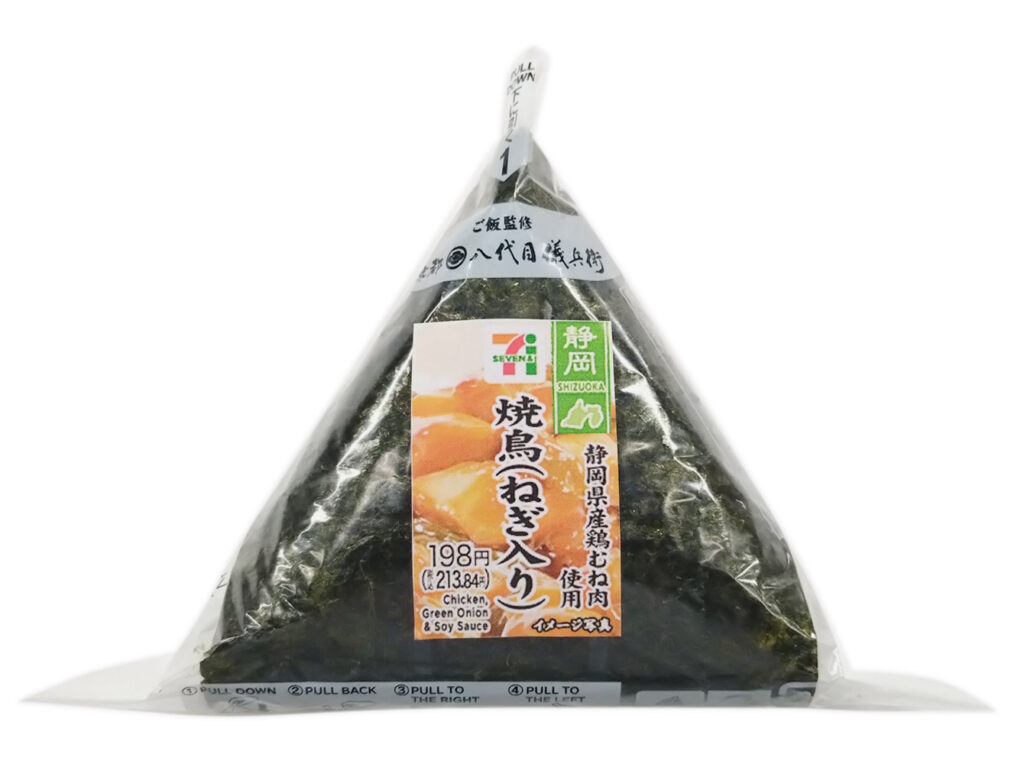 セブンイレブンの手巻おにぎり 焼鳥（ねぎ入り）を比較する。税込価格：214円、カロリー：197kcal、たんぱく質：5.8g、脂質：1.9g、炭水化物：40g、糖質：38.2g、食物繊維：1.8g、食塩相当量：1.4g。静岡県産ハーブ鶏のむね肉を使用した焼鳥のおにぎりです。アレルギー：卵、小麦。