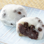 ローソンの塩豆大福を比較する。税込価格：214円、カロリー：186kcal、1円あたりカロリー：0.87kcal/円、たんぱく質：3.9g、1円あたりたんぱく質：0.02g/円、脂質：0.6g、炭水化物：42.7g、糖質：39.6g、食物繊維：3.1g、食塩相当量：0.2g。北海道産小豆を使用し、小豆の風味を引き出して炊き上げたつぶあんを、赤えんどう入りのもち生地で包みました。